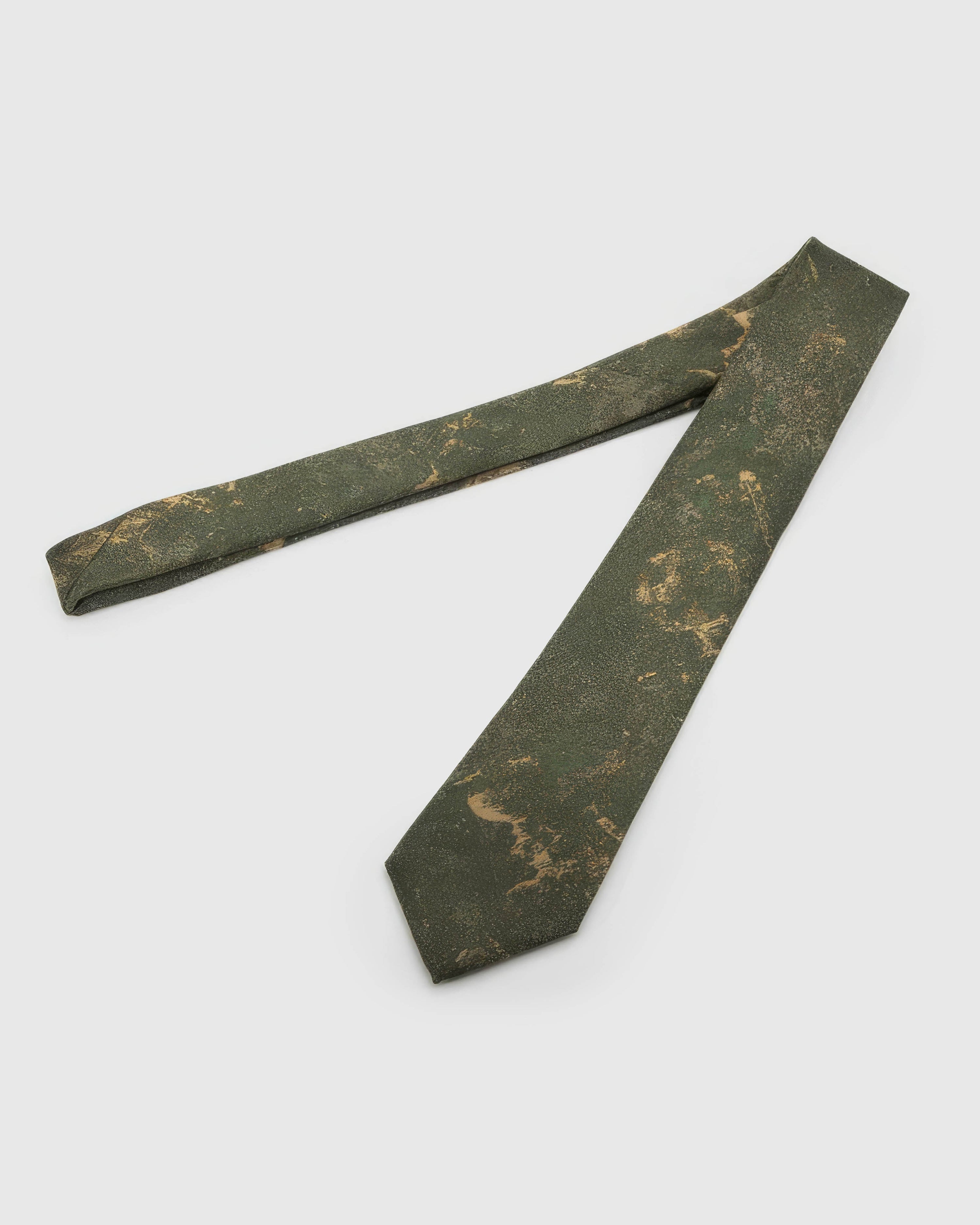 Forest Patina Tie laid full length to show forest and olive abstract patina with golden forms from blade to tail.