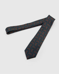 Petrol Copper Paisley Tie laid full length on white, showing a deep petrol ground covered in a fine copper-outline paisley repeat from blade to tail.