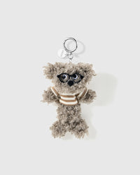 Grey curly poodle charm wearing black glasses and a brown striped top with a round silver-colour clip