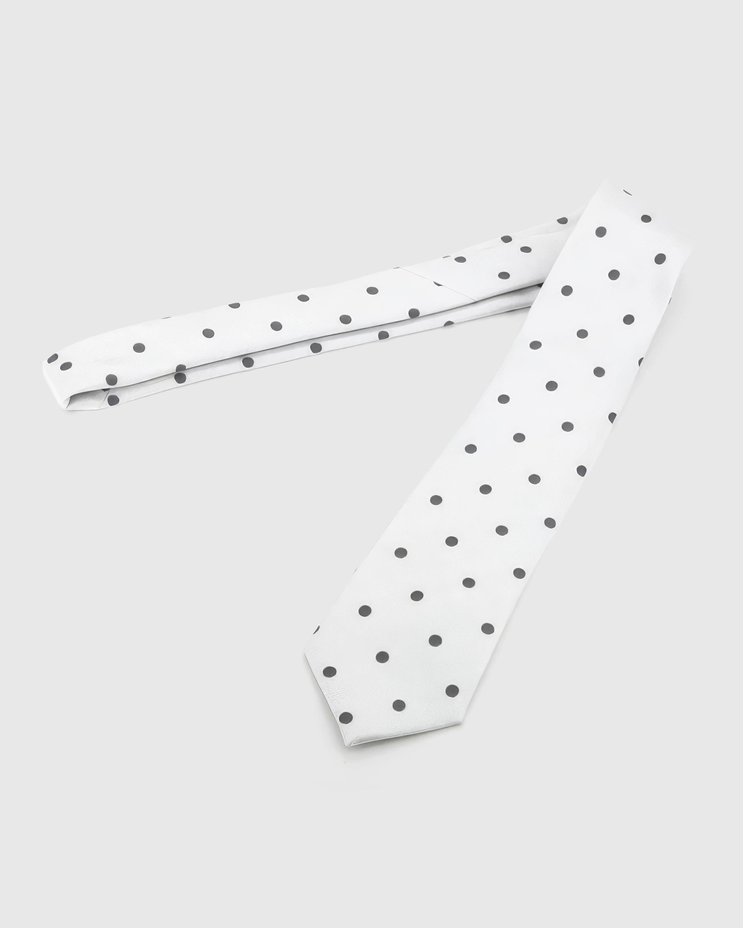 Full-length STICKYZOO Pearl Onyx Dot Tie laid flat on white, showing the complete onyx polka dots repeat and 145 × 8 cm proportions