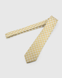 Champagne Sunburst Tie laid full length to show champagne ground with ivory sunbursts and slate centres from blade to tail.