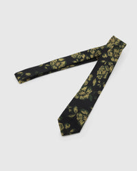 Noir Golden Rose Tie laid full length on white, showing a noir ground with large golden roses and deep-green botanical leaves from blade to tail.