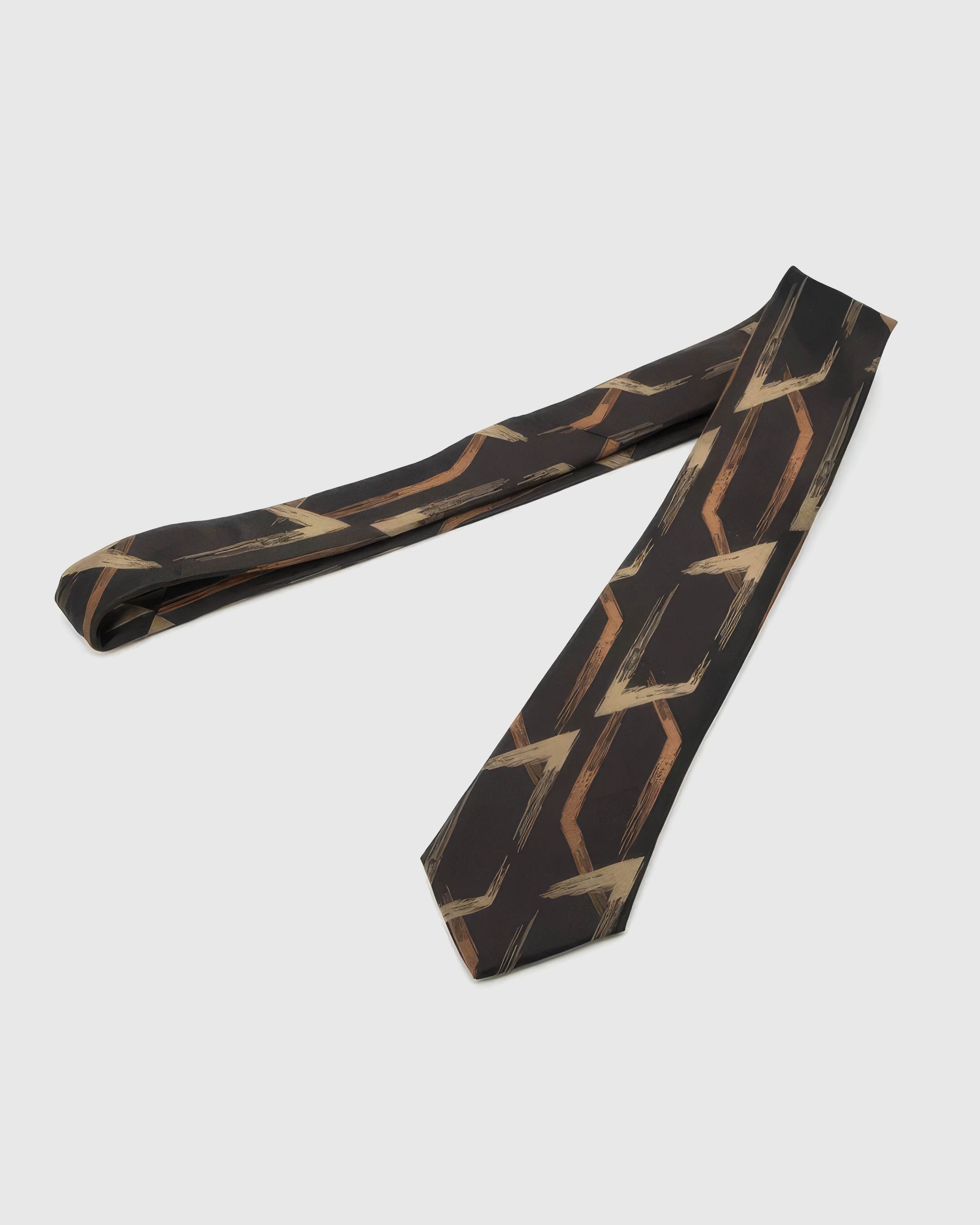 Full-length STICKYZOO Obsidian Geometric Arrow Tie showing copper-brass arrows across a 145 × 8 cm hand-finished mulberry silk tie