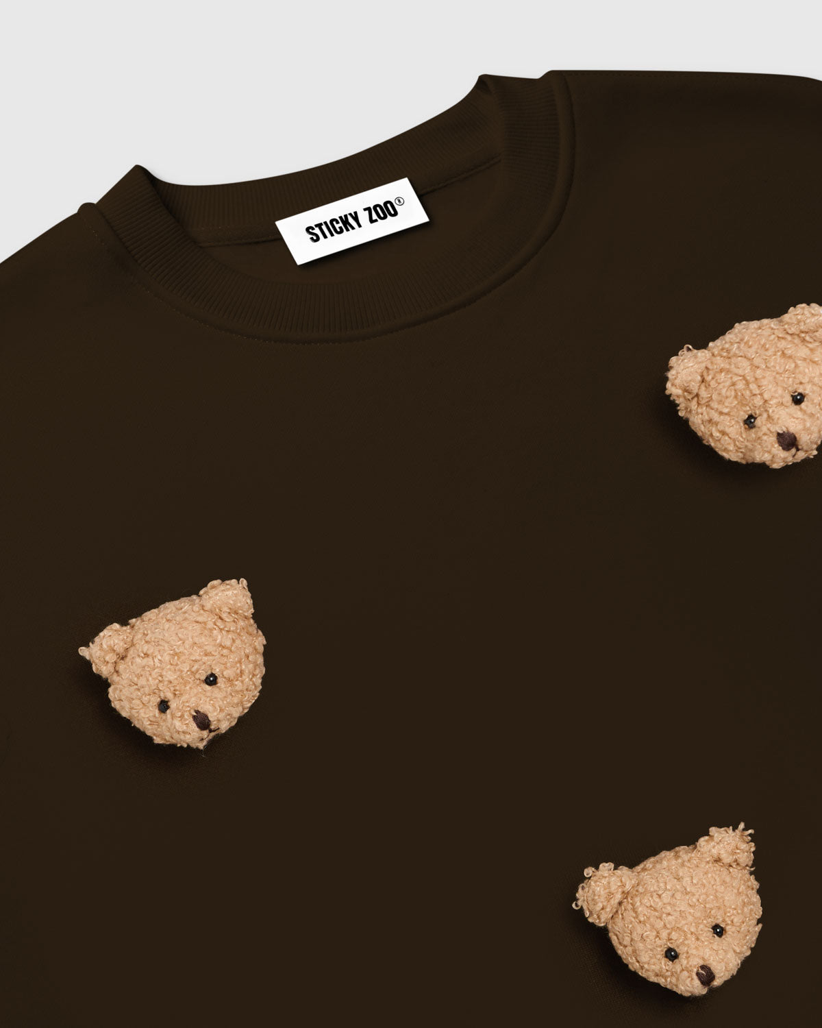 Flat-lay of Sticky Bear Sweatshirt in brown showing oversized silhouette and six bear appliques