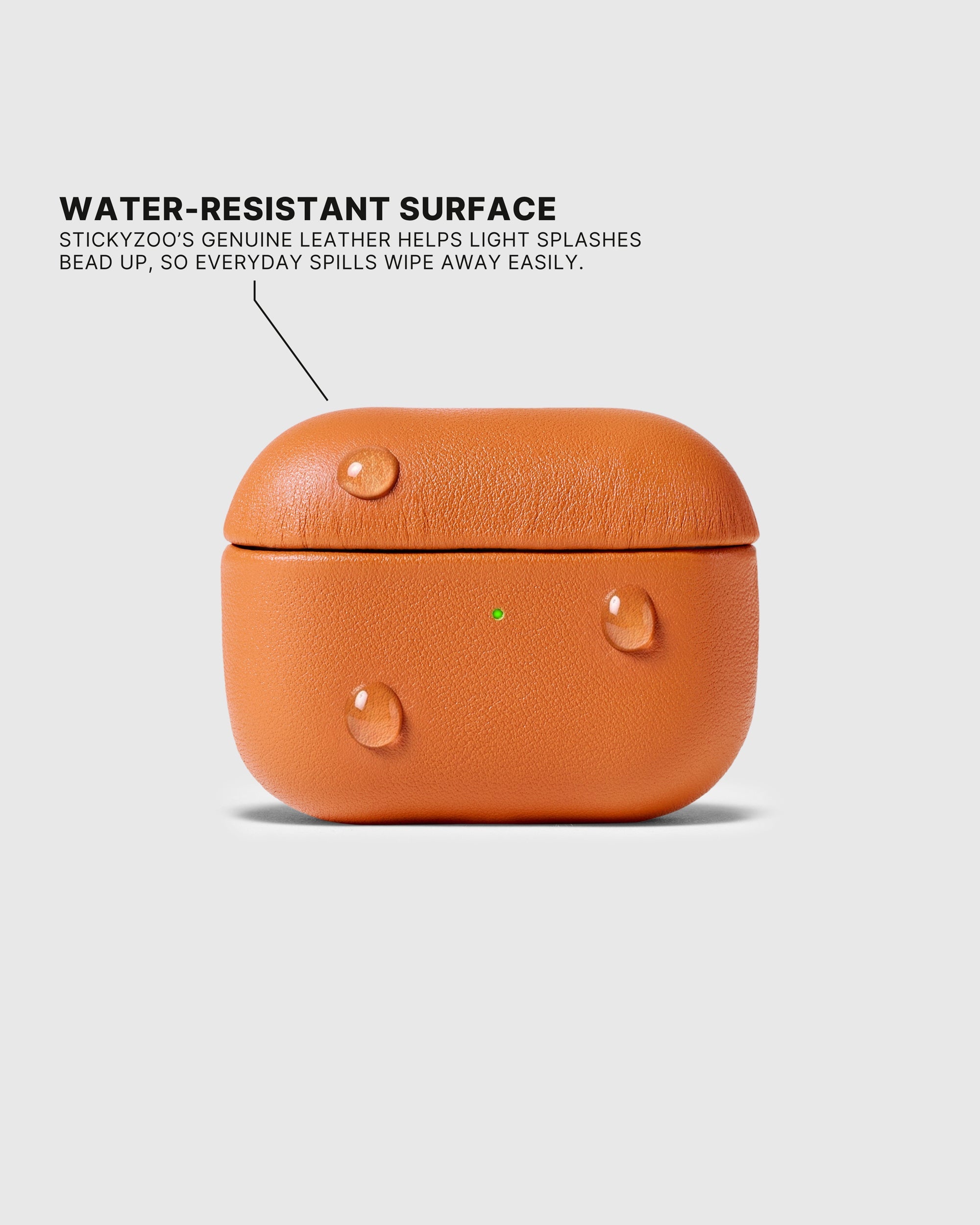 Water droplets beading on the Orange AirPods case surface