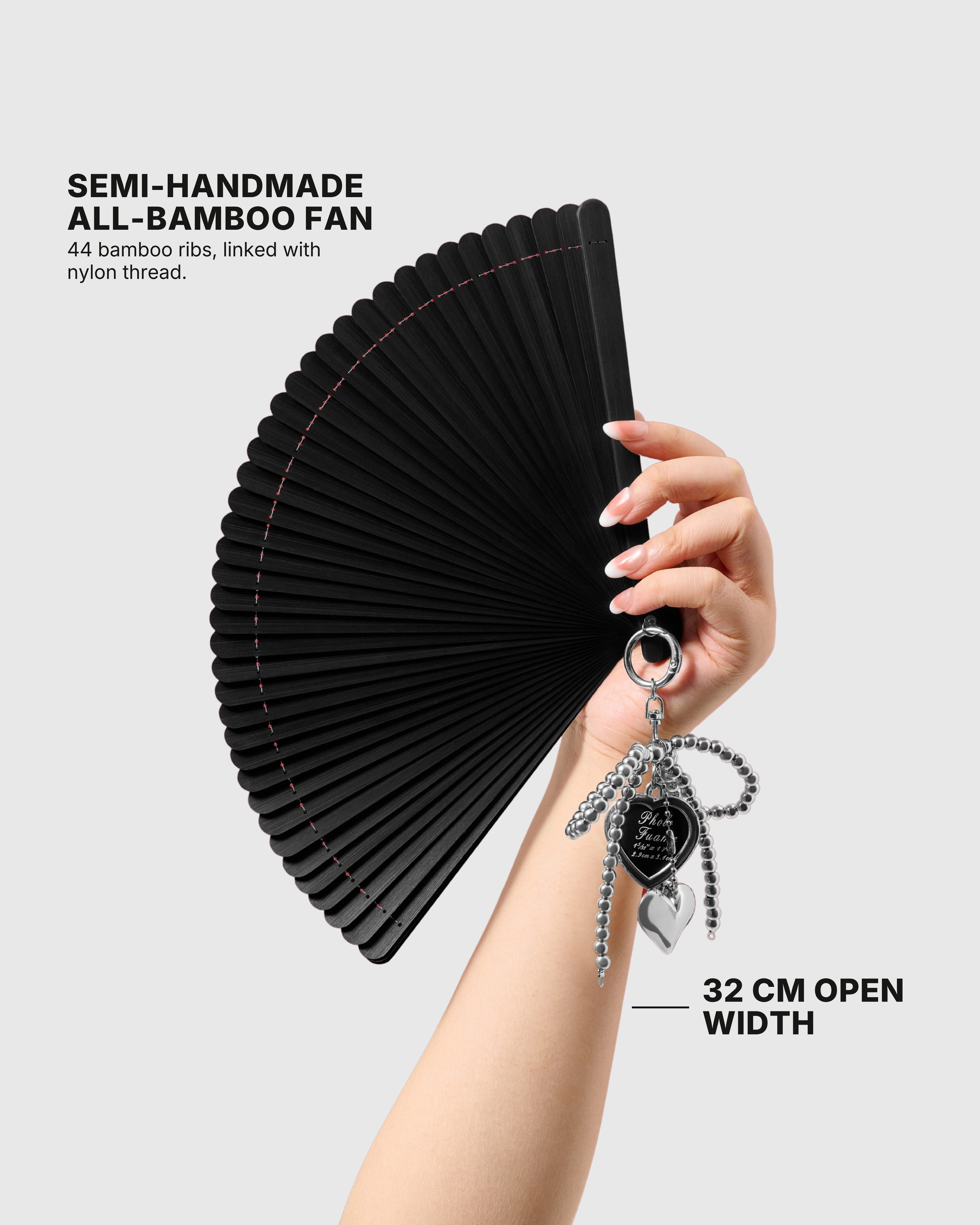 STICKYZOO black hand fan held open to show its 32 cm width