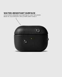 Water droplets beading on the Black AirPods case surface