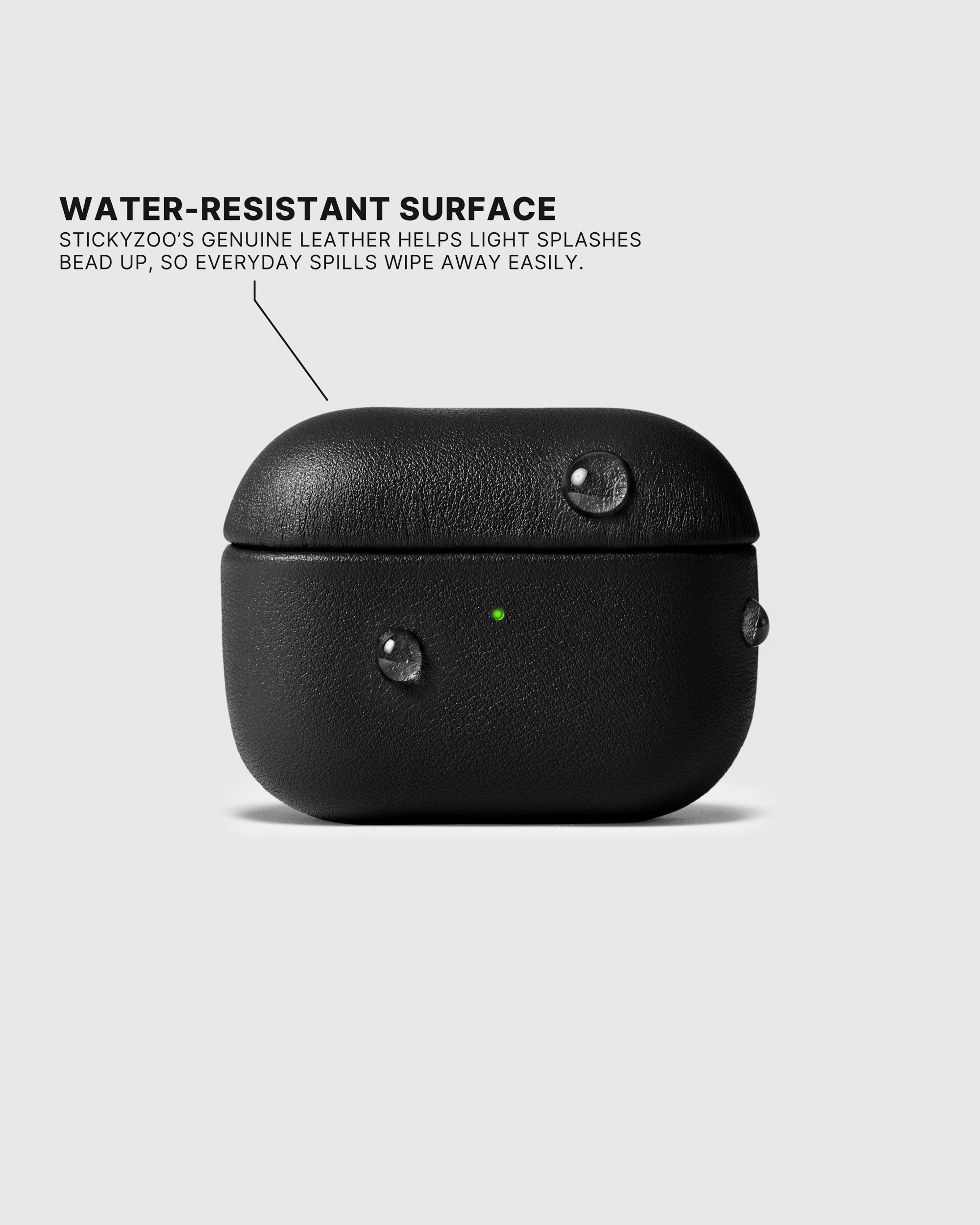 Water droplets beading on the Black AirPods case surface