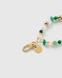 Close-up of the 18K gold-plated hook, engraved STICKYZOO disc and the green marbled and gold-tone beads — every one different