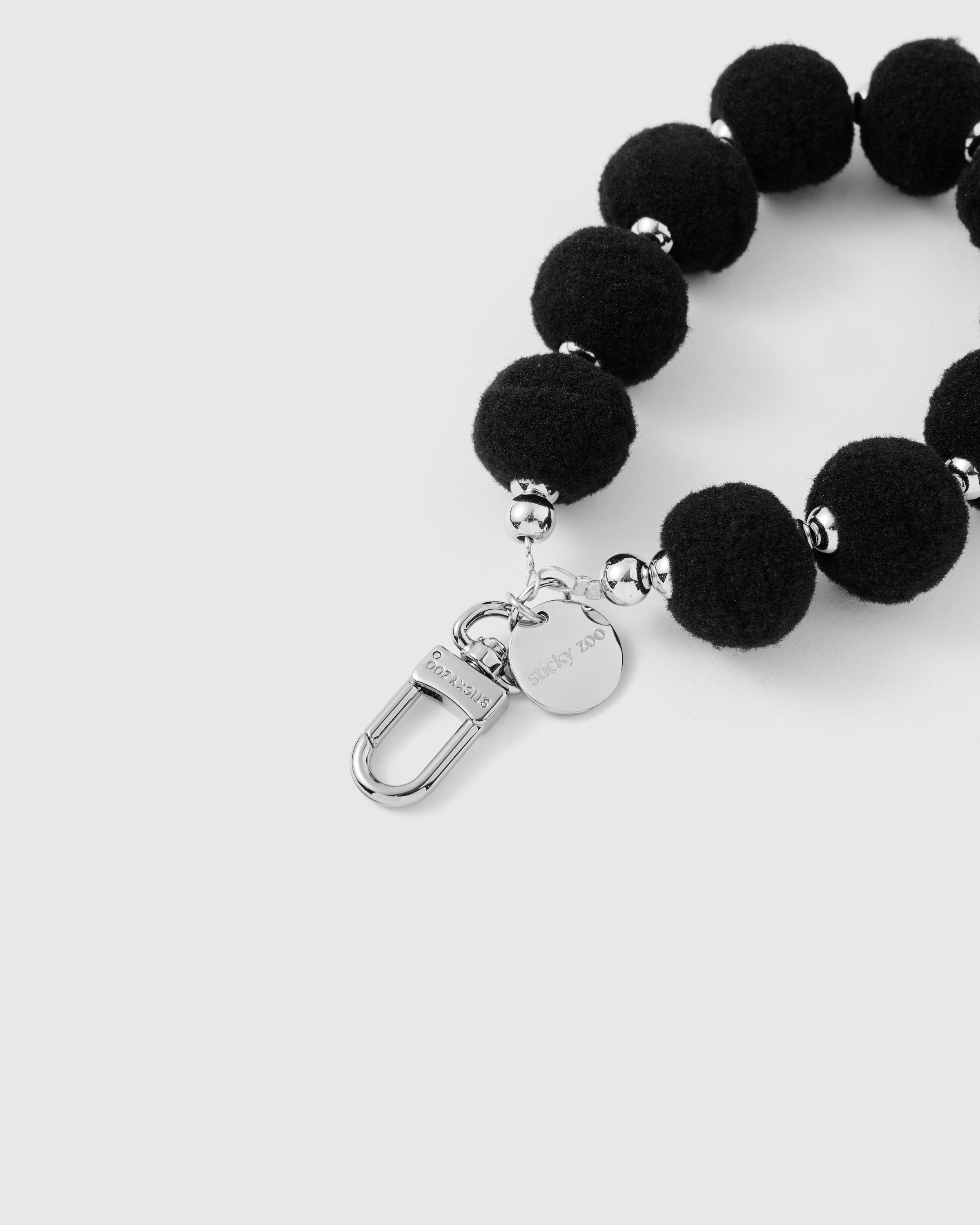BLACK POM PHONE STRAP