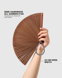 STICKYZOO espresso hand fan held open to show its 32 cm width