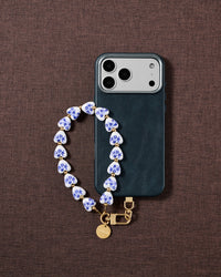 Porcelain heart phone strap styled on fabric, loved by thousands of STICKYZOO customers
