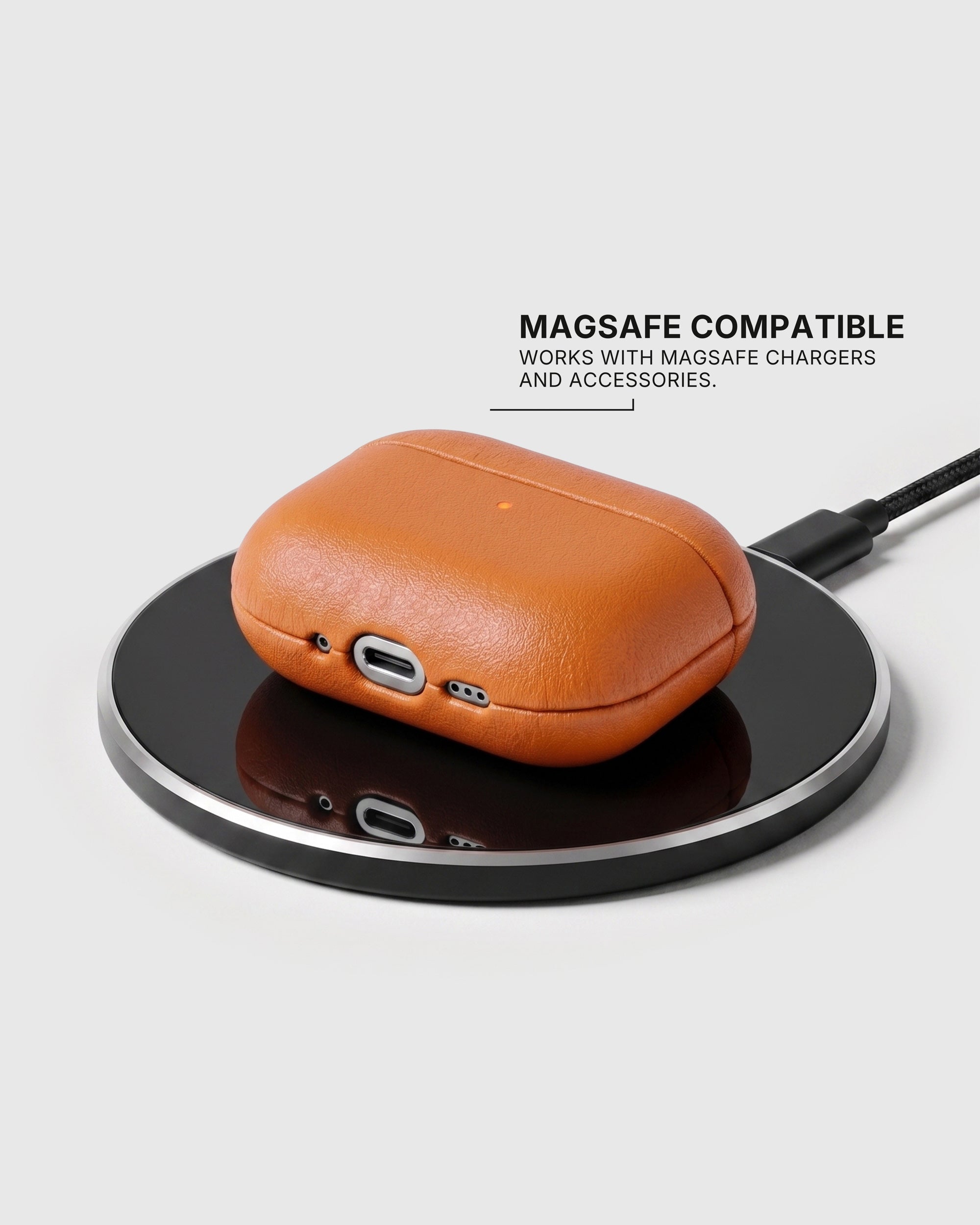 Orange AirPods case on a wireless charging pad with text stating MagSafe compatibility
