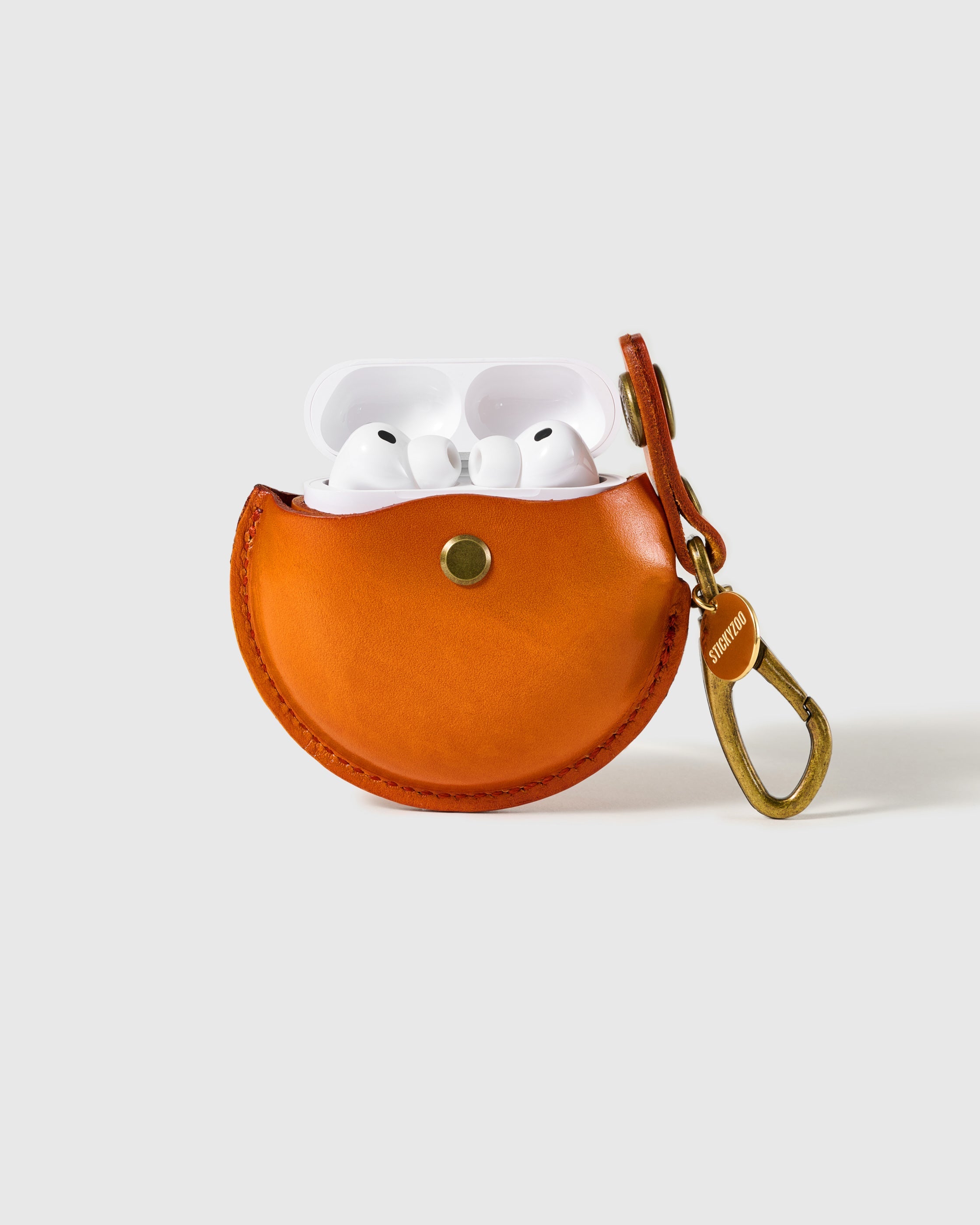 Cognac STICKYZOO Wave Pocket AirPods Case open to show the snap-close front