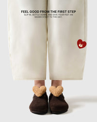 Heart-detail brown suede clogs worn on foot for an easy first step