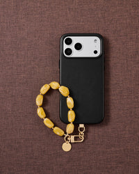 Amber marbled bead phone strap styled on fabric, loved by thousands of STICKYZOO customers