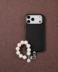 White pearl phone strap styled on fabric, loved by thousands of STICKYZOO customers