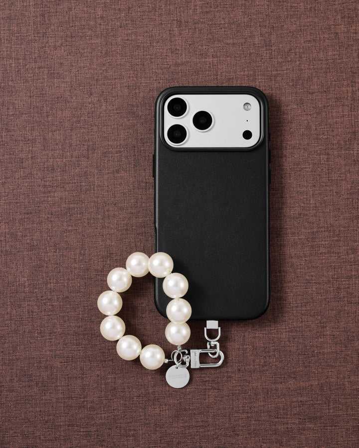 White pearl phone strap styled on fabric, loved by thousands of STICKYZOO customers