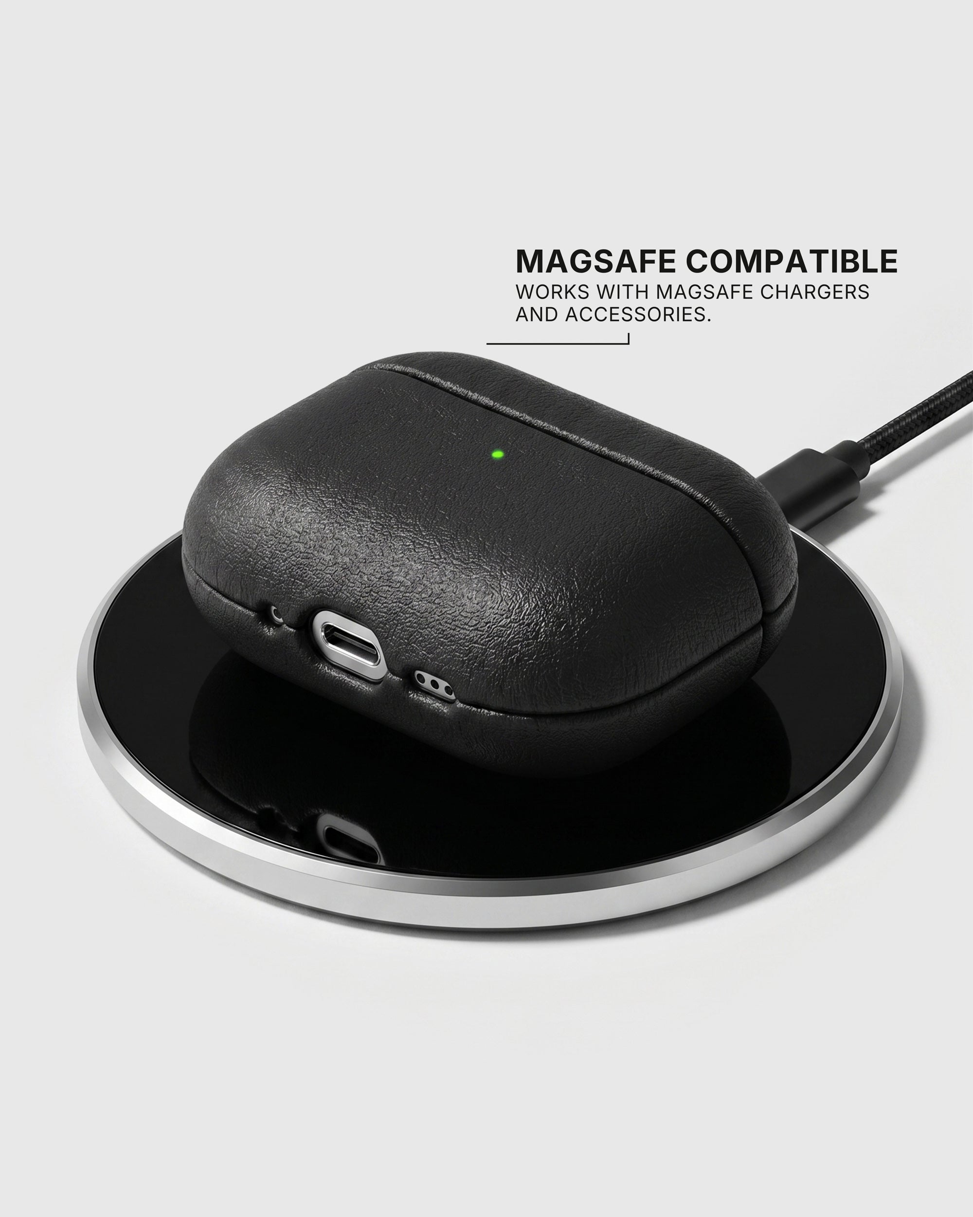 Black AirPods case on a wireless charging pad with text stating MagSafe compatibility