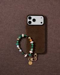 Emerald green mixed bead phone strap styled on fabric, loved by thousands of STICKYZOO customers