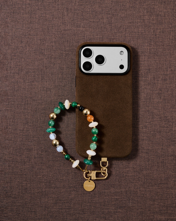 Emerald green mixed bead phone strap styled on fabric, loved by thousands of STICKYZOO customers
