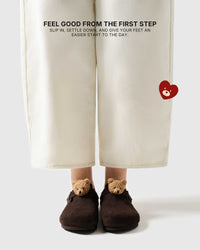 Teddy bear brown suede clogs worn on foot for an easy first step