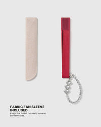 Close-up of three polished heart details on the silver-plated fan charm
