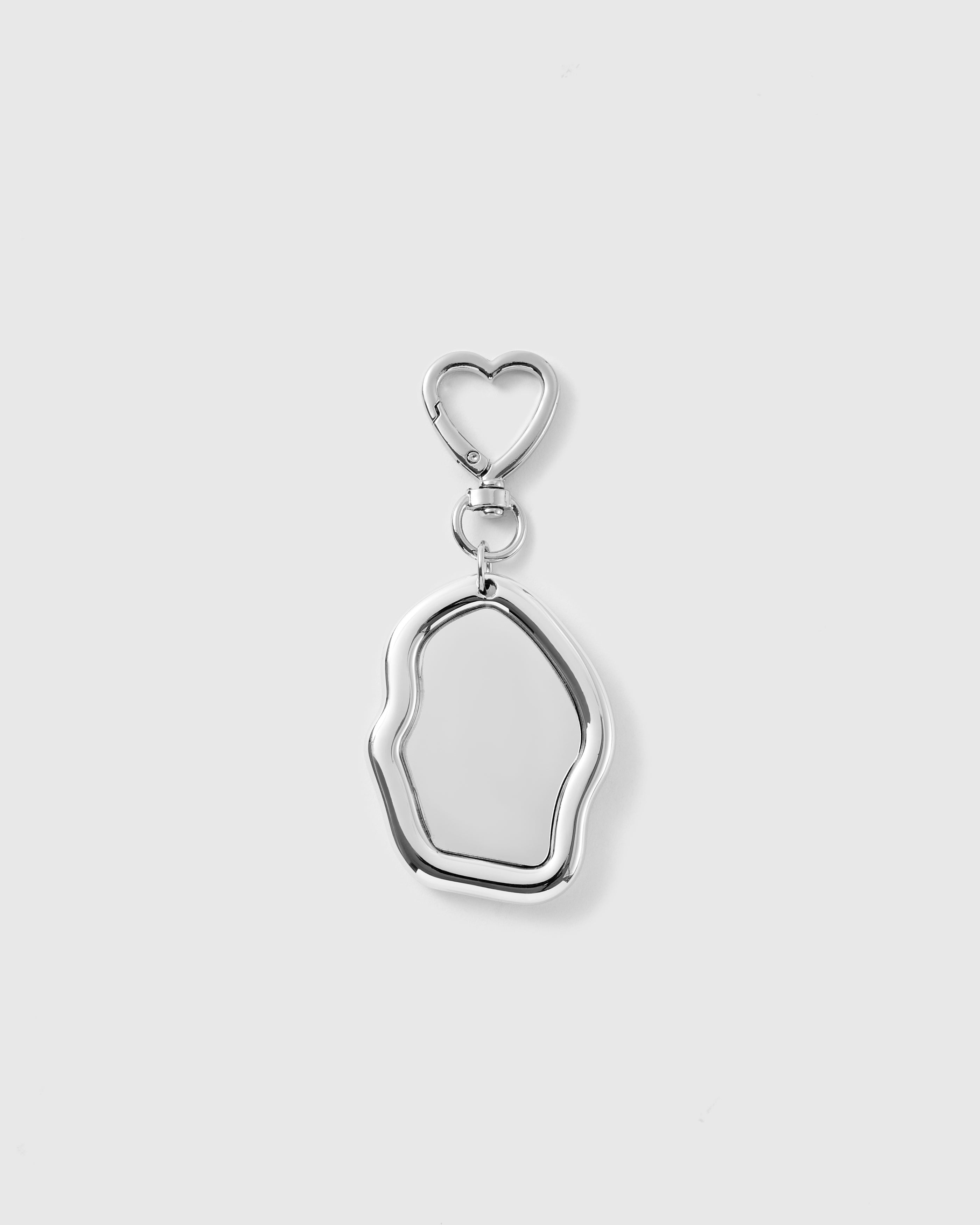 STICKYZOO Moonlit Pebble Mirror Charm with an irregular reflective mirror, polished silver-tone frame and silver-tone heart-shaped clasp